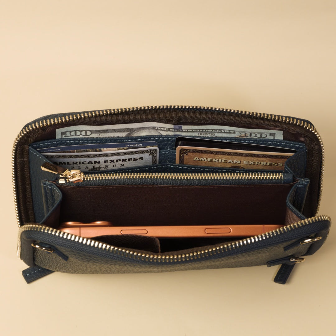 Open blue wallet with money and cards on a beige background